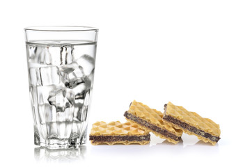Glass of pure water with ice cubes and Wafers with chocolate iso