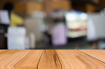 Selected focus empty brown wooden table and Coffee shop blur bac