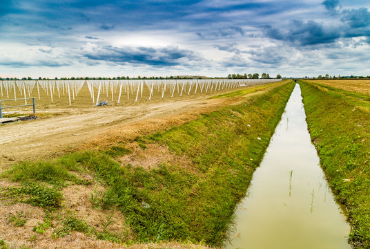 irrigation canal divides harvested land and plowed land with pr © Vivida Photo PC