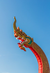 Fototapeta na wymiar Heads of Naka or Naga or serpent statue with blue sky