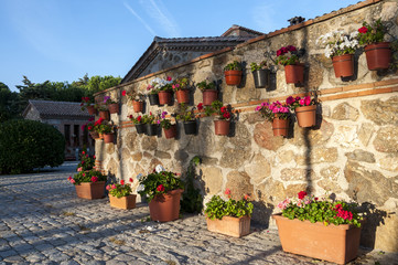 Flower pots hanged of the wall. Photo taken in hermitage of Our Lady of Remedies (Nuestra Señora de los Remedios), Colmenar Viejo, Madrid, Spain.