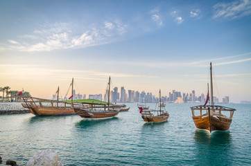 Dhows moored off Museum Park in central Doha, Qatar, Arabia, with some of the buildings from the...