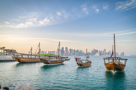 Fototapeta Dhows moored off Museum Park in central Doha, Qatar, Arabia, with some of the buildings from the city's commercial port in the background.
