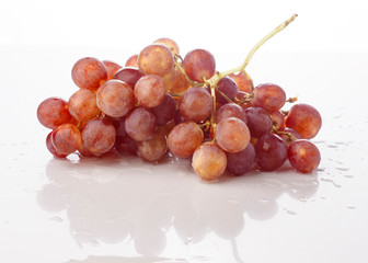 bunch of grapes in white base with water droplets wet