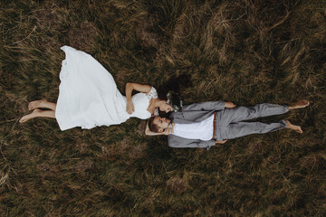 beautiful fabulous happy  bride and stylish groom lying down on © sonyachny