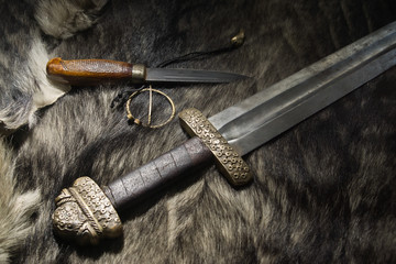 Viking sword and knife on a fur