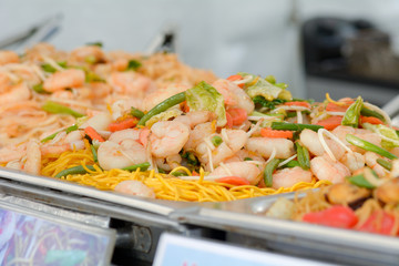 Row of dishes on hot plate at Chinese food stall at food festival