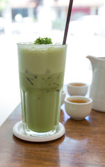 Green tea smoothie on a wooden table