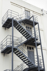 Grey fire escape on white building