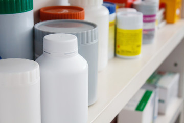 Bottles of pills arranged on shelf at drugstore