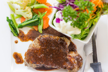 A dish of meat steak covered with herb