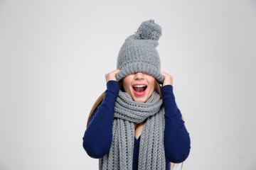 Woman covering her eyes with hat