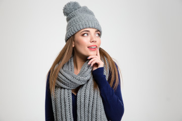 Smiling woman in winter cloth looking away