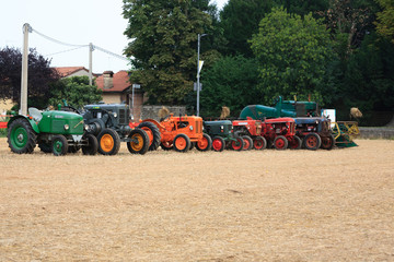 Nine old tractors in perspective, agricultural vehicle, rural life