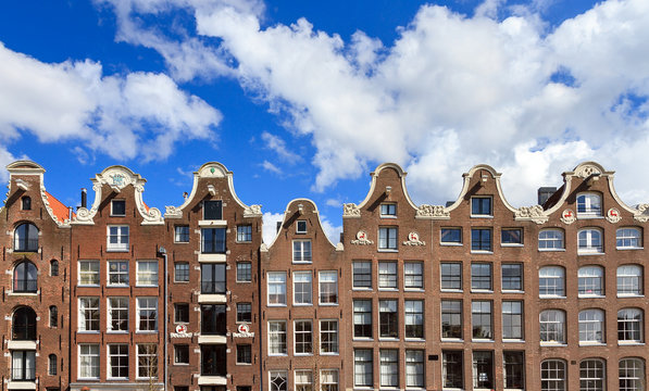 Dutch canal houses with a blue sky in Amsterdam in summer