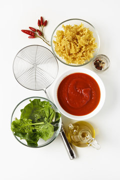 Ingredients for Cooking Vegetarian Pasta: tomato sauce, spinach,