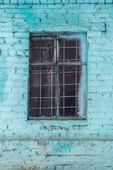 Blue brick wall with a window