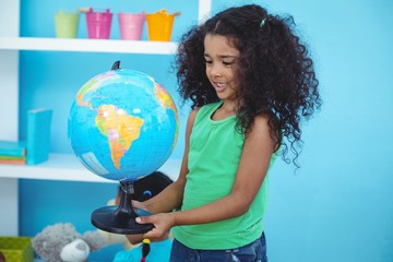 Small girl holding a globe of the world