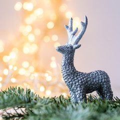 silver deer christmas decoration with christmas light in the background