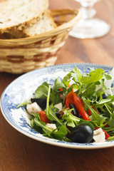 Arugula salad with turkey meat, baked capsicum and olives