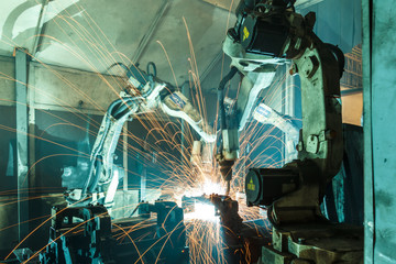 Team robot welding steel motion blur industry.
