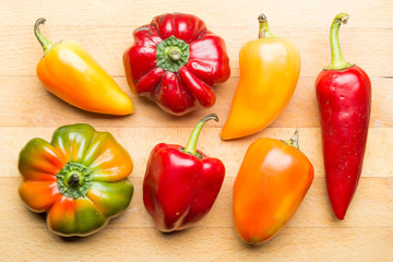 Yellow, Red, Orange and Green Peppers From my Garden on a Wooden Cut Board