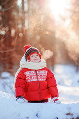 happy child girl with frozen breath on the walk in snowy winter forest, outdoor activities on holidays