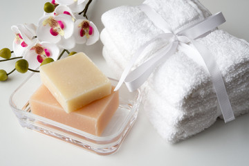 orchid, white towels and soaps