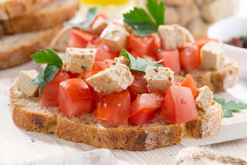bread with tomatoes and marinated feta, closeup