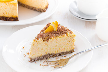 piece of orange cheesecake with chocolate on a plate