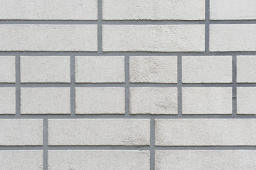 The grey brick wall with unusual pattern