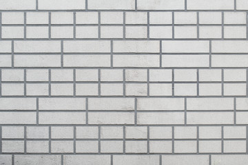 The grey brick wall with unusual pattern