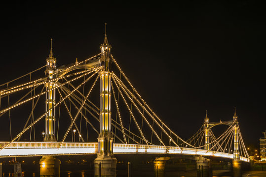 Illuminated Albert bridge in west London at night