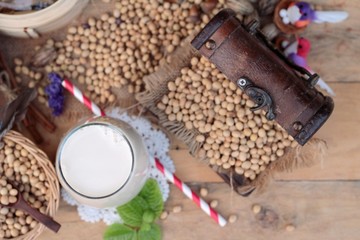 Fototapeta na wymiar Soy milk and soybeans on wood background.