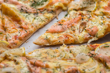 Delicious salmon pizza in a cardboard box