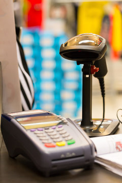 Barcode scanner on table with credit card machine (selective foc