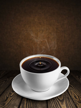 Cup of coffee on wooden background.