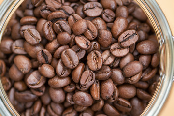 Coffee beans in a glass bowl. Shallow dof