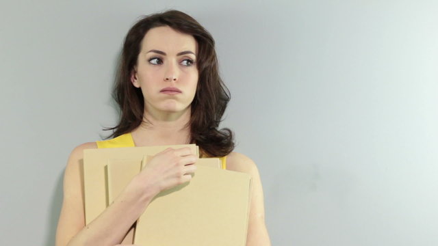Young woman holding folders waiting for someone