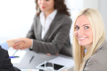 A group of business people at a meeting on the background of office. Focus on a beautiful blonde