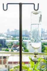 Intravenous bag on a pole. It is connected to Intravenous lines.