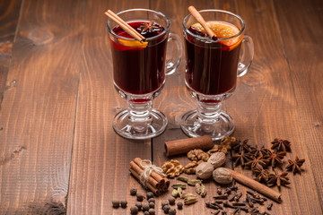 Christmas hot mulled wine with spices on a wooden table. The idea for creating greeting cards