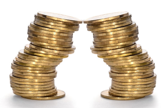 Coins from yellow metal isolated on a white background