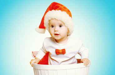 Christmas and people concept - beautiful baby in santa red hat g