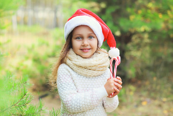 Christmas and people concept - portrait little girl child in san