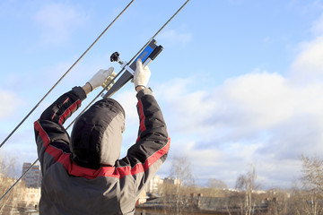 measurement of cable tension. engineer measures the tension of the metal cable special device ...