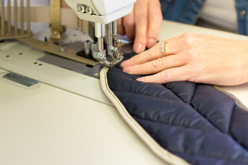 Sewing Process - Woman's hands behind her sewing