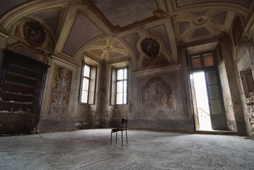 Chair in an ancinet  and abandoned mansion , Italy