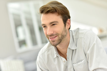 Portrait of handsome man sitting at home