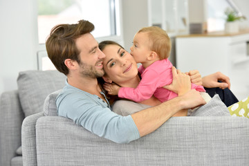 Couple with baby girl enjoying family time at home
